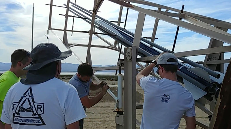 Odhner and his fellow engineers prepare to launch their rocket. Odhner and his fellow engineers prepare to launch their rocket.