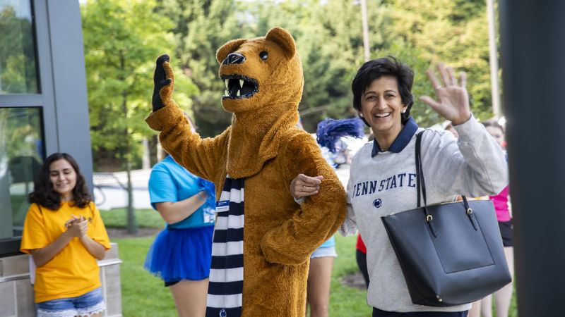 Nittany Lion mascot, left, waves to the crowd with Chancellor Pyati, right