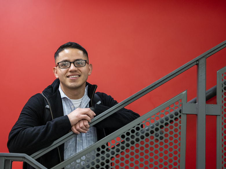 Adult learner standing on stairs in Gaige Building