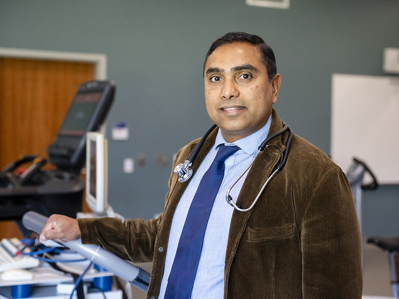 Faculty member poses for photo in kinesiology classroom