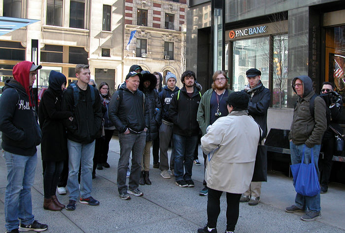 Tom Lynn (pictured fourth from left) and his students listened to a presentation by Beatles expert Susan Ryan (foreground).