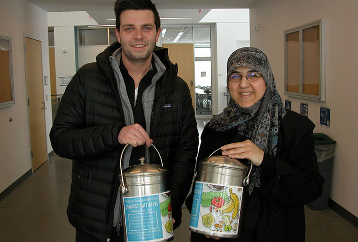 Senior Dakota Schoppe (left) and Dr. Mahsa Kazempour are pictured with the composting containers now found across campus. 