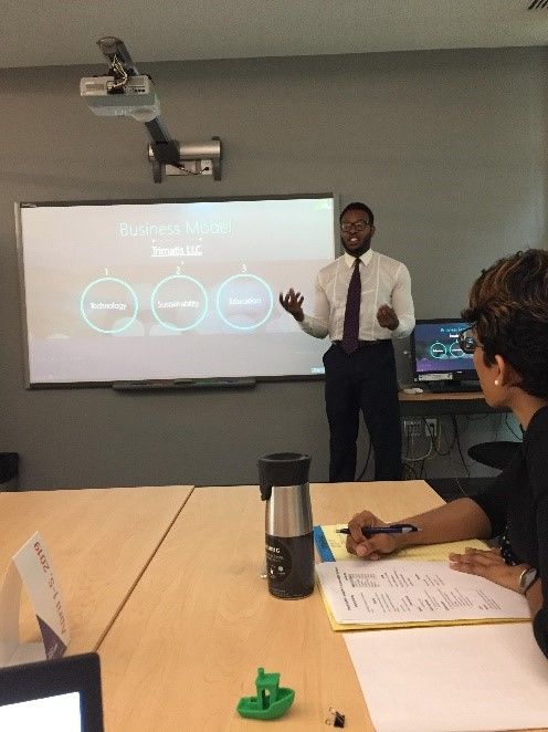 Tito Orjih gives a presentation about business models.
