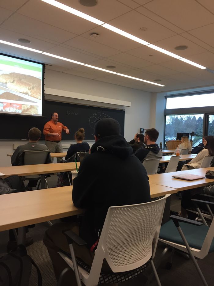 Students listen to a presentation by Waffatopia co-owner