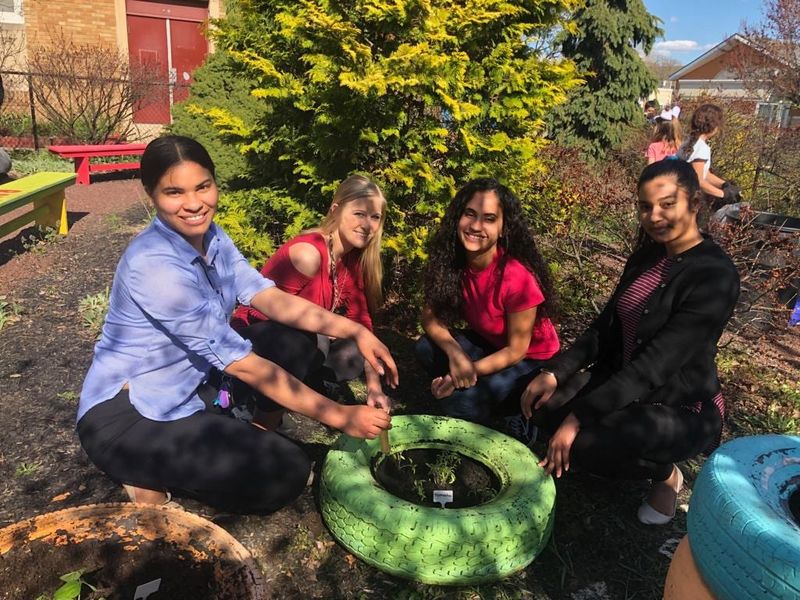 Penn State students help plant with the gardening club at Glenside Elementary