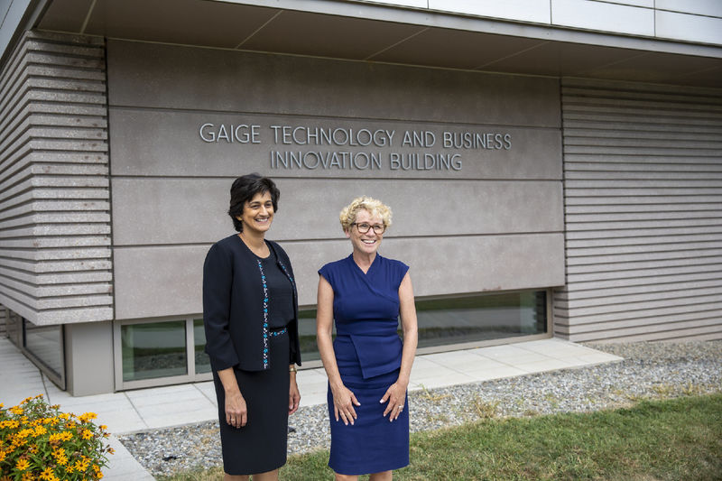 Chancellor Pyati and Rep. Houlahan pose in front of the Gaige Technology and Business Innovation Building sign