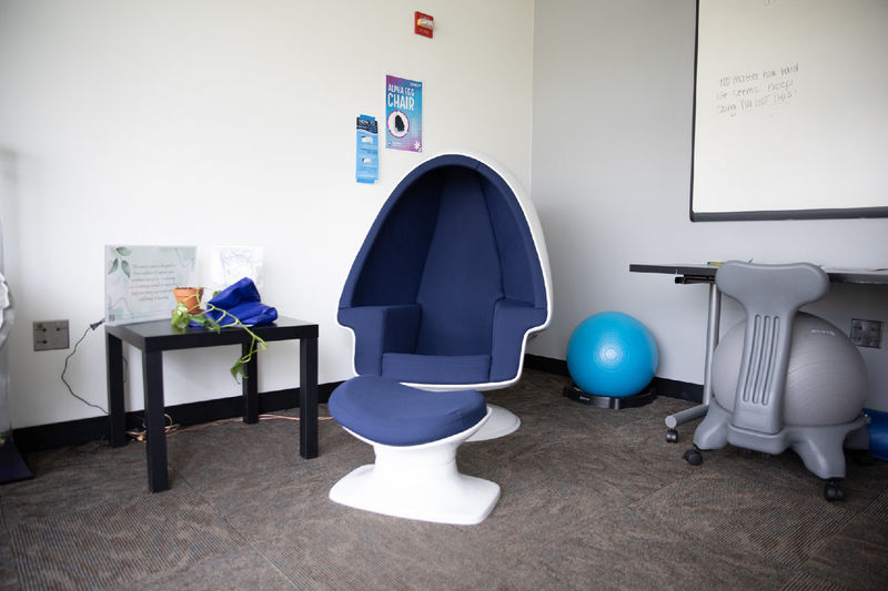 An egg-shaped chair and medicine balls sit in a quiet place.
