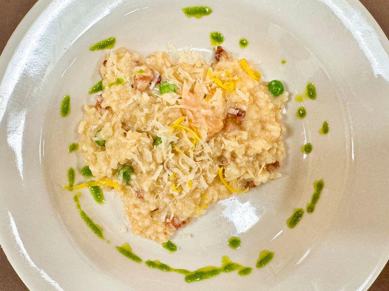 Photograph of rice dish with a shrimp and green sauce