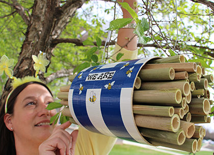 student with bee house