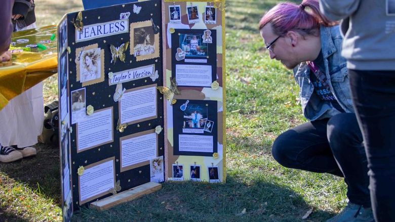 Community member reading student's research poster