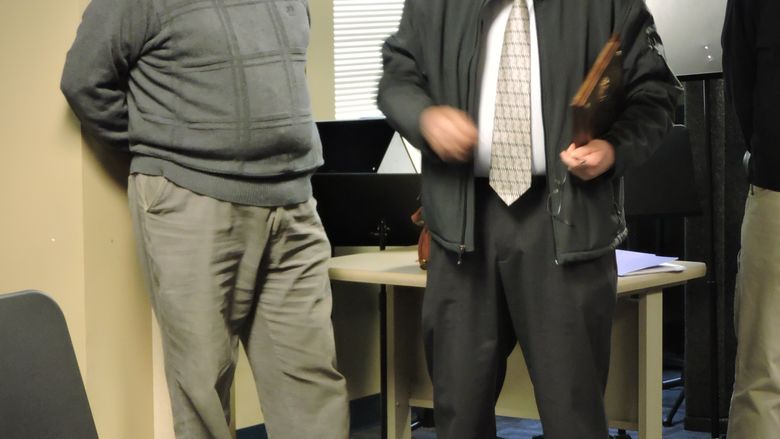 Officer Bill receives a plaque from a colleague