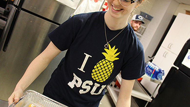Student serves dinner at Opportunity House.