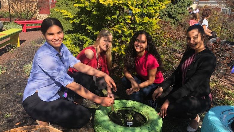 Penn State students help plant with the gardening club at Glenside Elementary