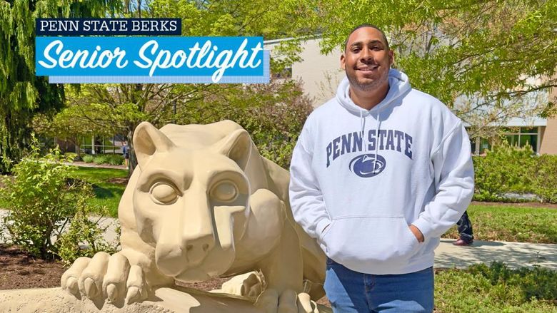 Christian Clarke standing by the lion shrine