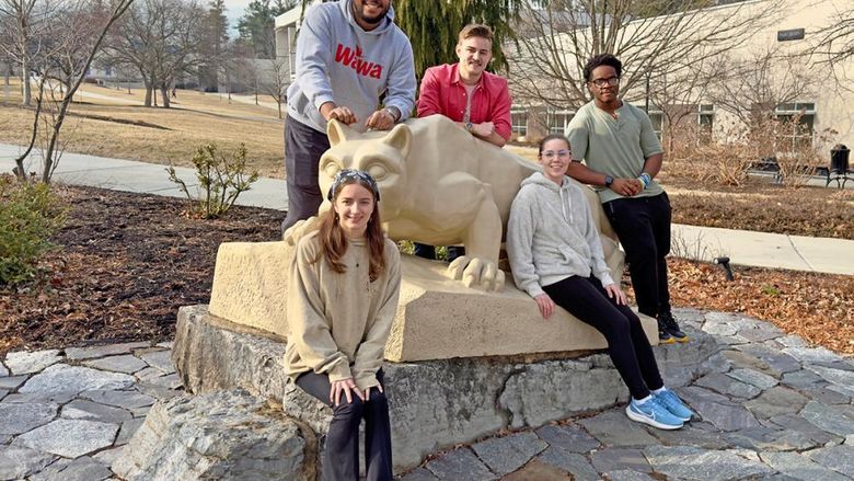 Berks student members of the team are pictured by the Lion Shrine.