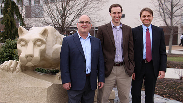 professors in front of lion