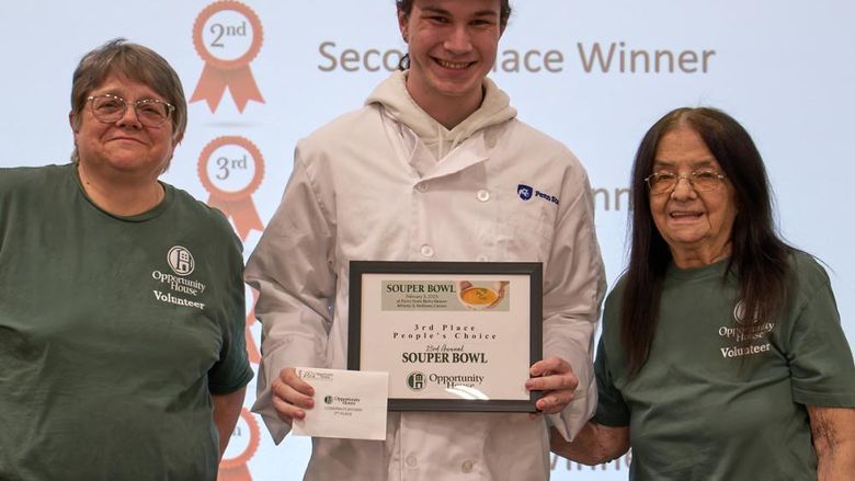 Student Souper Bowl winner is pictured with Food Services staff.