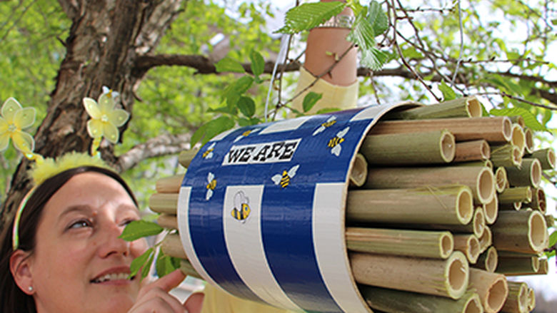 student with bee house