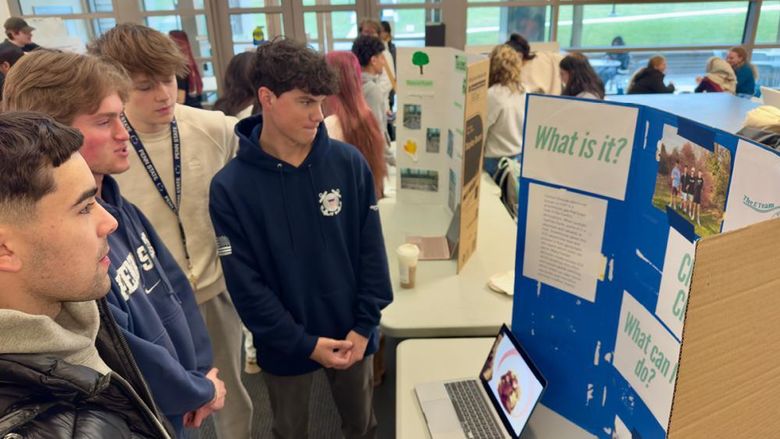 Students looking at a poster display
