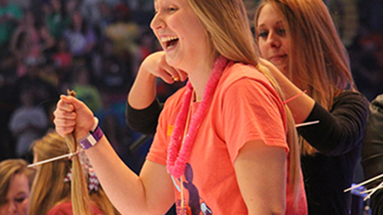 student getting hair cut at THON