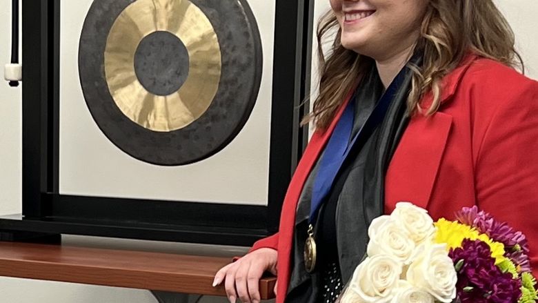 Viktoriia Vozharenko, a Scholar at Penn State Berks rings the gong