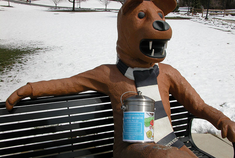 The Nittany Lion statue with a compost container. The Nittany Lion statue with a compost container.