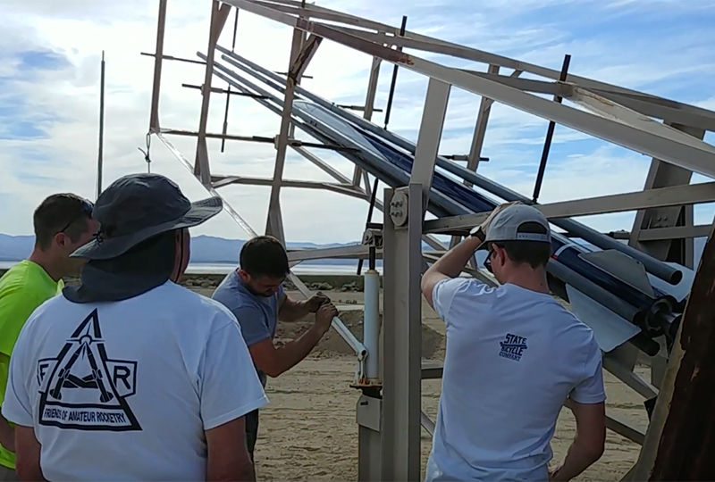 Odhner and his fellow engineers prepare to launch their rocket. Odhner and his fellow engineers prepare to launch their rocket.