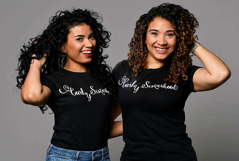 The Varona Sisters pose with their Curly Sisterhood t-shirts.