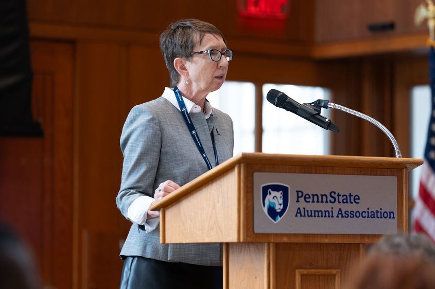 A woman giving a speech at a podium
