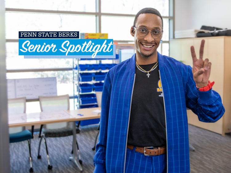 Brandon Everett holds up a peace sign with text reading "Penn State Berks Senior Spotlight" appearing over image