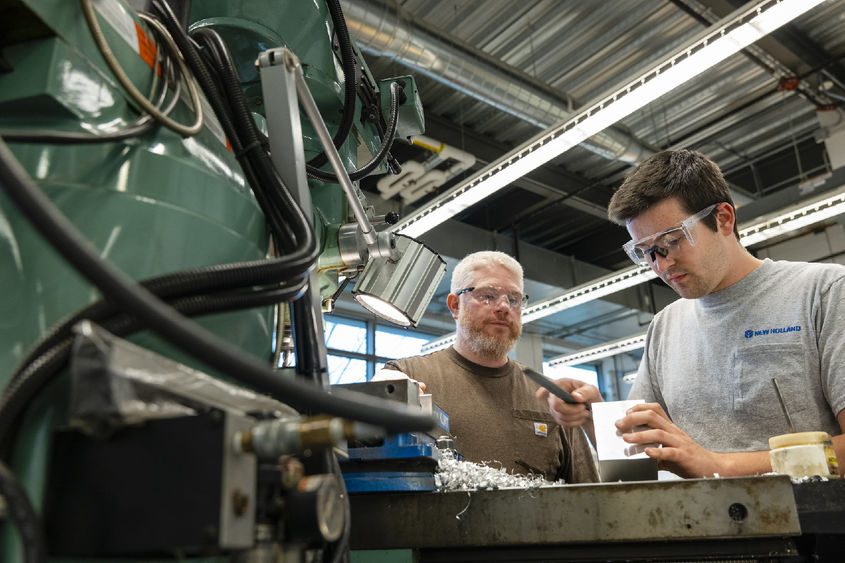 Student and instructor working at MILL machine