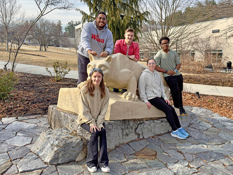 Berks student members of the team are pictured by the Lion Shrine.